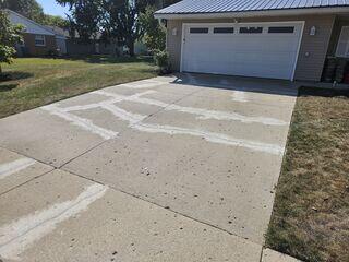 This photo was taken after we sealed the driveway cracks with our SealantPro. We used a matching color sand to blend the sealant into the existing color of the concrete. We had to use more sand than normal to erase the mismatching color of the old sealant, but it was well worth it.