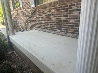 The porch slab showed cracking and signs of settlement, pulling away from the foundation.