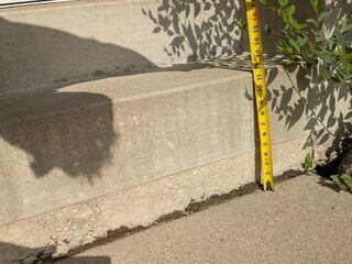A close up to see how far the slabs have sunken in front of the step
