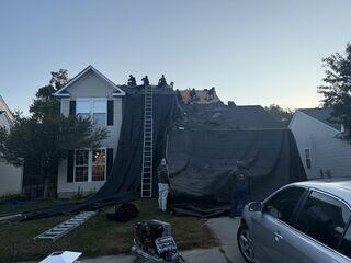 When we removed the existing shingles, we made sure to tarp the home to control the debris removal process.