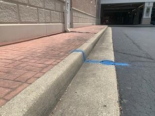 This next section, near the parking garage, was commonly used by patrons. The gap near the downspout was probably caused by water.