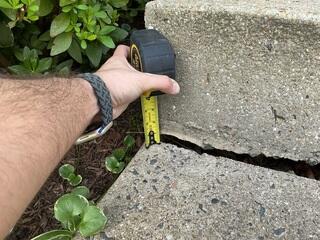 Noticeable signs of the concrete sidewalk settling