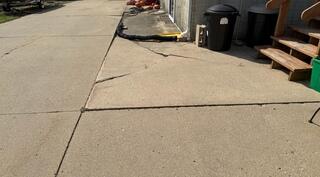 Before: Our Design Specialist recommended installing PolyLevel below the sinking and uneven slabs.
