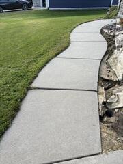 Before: Our Design Specialist, Ross, recommended leveling the sidewalk back into place.