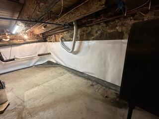 CleanSpace® Wall System: A bright, durable vapor barrier was installed over the interior walls. This system not only improves the appearance of the basement but also directs any seepage into the drainage system while preventing moisture from evaporating into the air.

DryTrack® Drainage System: Installed along the perimeter, DryTrack collects water seeping from the wall-floor joint and channels it directly to the sump pump without clogging or disturbing the footing.