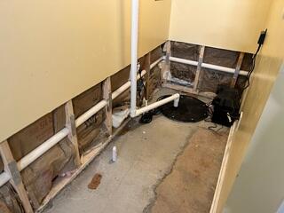 This photo, also taken upon the initial inspection, shows the worn down sump pump. It was receiving too much sediment, causing it to completely break down in less than a year.