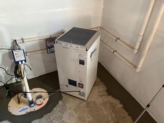 The SaniDry XP dehumidifier keep humidity in the basement low and drains itself into the TripleSafe sump pump. The TripleSafe sends all of the water out of the home through the discharge lines.