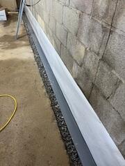 This was what the drainage system looked like after we fitted the trenches with the WaterGuard. We also pitched the drains slightly towards the sump pump with a gravel backfill.
