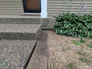 Before: Our Design Specialist, Kyle, recommended securing Helical Piers below the sinking slabs and lifting the structure back to its original position.