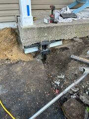 During: Our Foreman, Jose, and his crew worked hard to secure the Helical Piers below the damaged slabs.