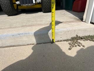 A close up of where the garage and driveway meet