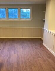 This image shows the completed project with our Elite Plank Flooring in the color "Walnut" and our EverLast Wall Restoration system!