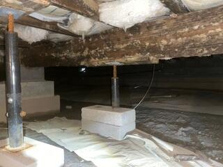 This photo, also taken upon the initial inspection, shows the rusted lally support column. The high moisture content in this space wasn't just ruining the wood, it was also torturing everything else, (the plumbing, the ducts, the fiberglass, even the concrete walls).