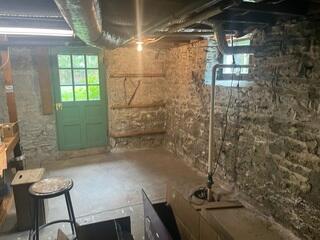 Old sump pump discovered during the initial inspection, showing signs of wear and limited capacity to handle heavy water flow. This homeowner was tired of their current exterior drainage system as well.