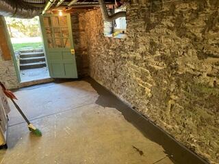 Final section of WaterGuard completed, sealing the system edge-to-edge along the basement perimeter.