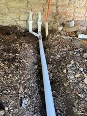 IceGuard outlets installed beneath the deck to protect the discharge line from freezing and backups.