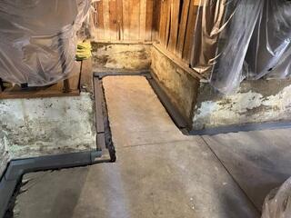 WaterGuard positioned into the trench before we pitched/fitted it all together. Note the wall flange that captures wall leaks directly into the system.