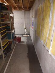 WaterGuard® Interior Drainage System: Installed along the interior perimeter of the basement floor, WaterGuard captures groundwater seepage from the walls and floor joint, directing it safely to the sump pump. Its clog-resistant design ensures long-term reliability.

TrenchDrain™ System: To address surface water entering through the bulkhead area, a TrenchDrain was installed and connected directly to the WaterGuard system. This ensures that any water entering near doorways or entry points is immediately collected and diverted.

TripleSafe® Sump Pump System: The heart of the waterproofing solution, the TripleSafe provides three levels of protection - a primary pump, a secondary pump for heavy flow, and a battery backup pump for peace of mind during power outages.