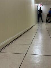 Slab settlement of floor slab below interior wall.