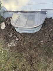 This image shows the finished egress window with the cover installed. The clear, durable cover keeps out rain, leaves, and debris while still allowing sunlight to pass through. It gives the project a neat, finished appearance from the outside and ensures long-lasting protection for the window well below.