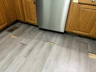 This photo shows what the kitchen floor looked like upon the initial inspection. Not only was it unsightly, but the homeowners were also dealing with sticky cabinets.