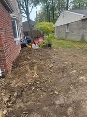 This photo was taken upon completion. We backfilled the piers with soil to conceal them completely after the home was lifted back up.