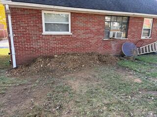 This shows the opposite side of the wall from the outside. We had to excavate the soil down along this wall in order to straighten it out. We also applied a TVB (topsite vapor barrier) to the wall from the outside to stop moisture from further degrading the concrete blocks. This was after we backfilled the hole and the project was complete.