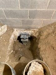A steel Push Pier installed deep beneath the foundation, reaching stable soil to provide lasting support.