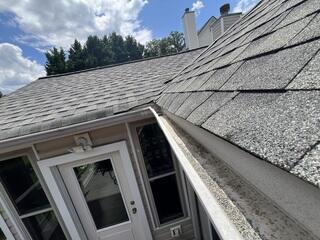 Open K-style gutters collect debris, forcing homeowners to climb ladders for maintenance.