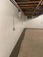 First, our WaterGuard Drainage System was installed to capture groundwater along the basement perimeter and channel it safely to the sump pump, preventing water from seeping into the living space.