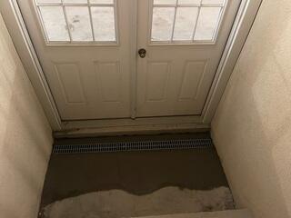 Next, the team added our TrenchDrain System to collect surface water at basement entryways, directing it into the drainage system to stop pooling and protect floors from water damage.