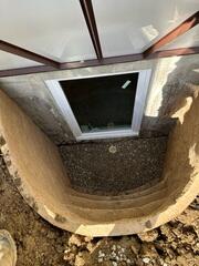 This is what the inside of the well looked like after installation. You can see the gravel base with the vertical drainage pipe in the center.
