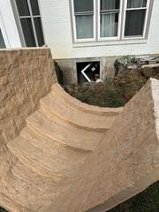 This photo shows a close up of the tan RockWell. This well mimics the pattern of natural stone, and has built in stairs for safe and easy access. This well also comes in a gray color as well.