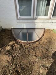 This is what the translucent lid looks like. This polycarbonate lid is light enough to be opened by anyone. It is also durable enough to support 500 pounds, though you should never step on it. This lid allows lots of light to emit into the basement.