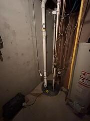 The PVC pipe is installed in the sump pump system and is connected to the fan