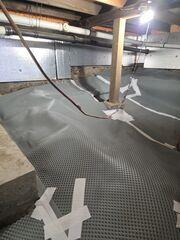 Drainage Matting was placed across the crawl space floor to create a raised pathway that directs groundwater toward the drainage system.