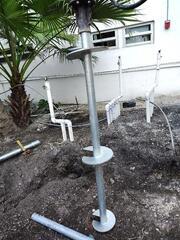 Installing helical piles around Coy Pond utilities.