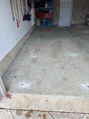 Concrete slab at the garage entrance raised back to grade, eliminating the trip hazard.