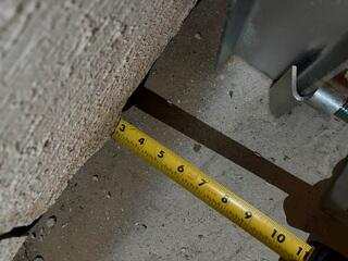 This ruler actually doesn't start at the three mark. The other three inches are hidden underneath the sheared part of the wall. This photo was taken before the straightening process, and the angle was snapped from the camera looking straight down at the floor near the wall.