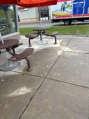 Visible slab sinking is evident across this commercial dining area due to poor drainage and heavy foot traffic. The difference in height between the settled slabs required immediate leveling to ensure safe accessibility for patrons.