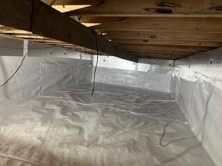 CleanSpace was installed to permanently seal the crawl space. This heavy-duty, reinforced liner covers the floor and walls, effectively isolating the home from ground moisture, soil gases, and external humidity, ensuring a completely dry environment.