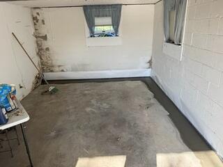 Finished Project: The backside of this garage is now waterproof. We were even able to run the drainage system past the interior wall on the left to the other room in the garage, (as seen in the previous photo).