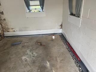 Step 3: We then installed our WaterGuard drains by pitching them with gravel.