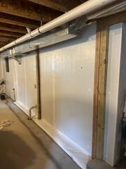 We installed our WaterGuard Drainage System to capture groundwater at the foundation's perimeter before it could reach the basement floor. This innovative system directs water safely to the sump pump, preventing seepage, protecting the walls, and keeping the basement dry and structurally secure.