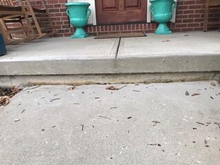This photo was taken upon the initial inspection and shows just how far the sidewalk had settled into the ground. When the sidewalk was first poured, it left no room between the porch slab and the top of the sidewalk.You can see that there was about a two to three inch gap before we raised it back up.