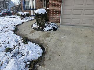 This photo was taken after we finished the project. The sidewalk now rests above the mulch pile, and the tripping hazards were all eliminated.