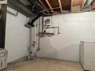 Completed system with WaterGuard perimeter, SuperSump, and Foamax wall liners fully installed, creating a dry and reinforced basement.