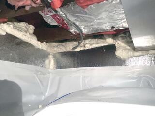 After sealing the ducts, we installed rigid foam boards on the walls and a vapor barrier on the floor to help prevent moisture buildup.