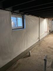 CleanSpace wall liner installed along the basement walls, creating a durable moisture barrier and directing water into the drainage system.