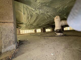 Spray Foaming underbelly of home in Apalachin